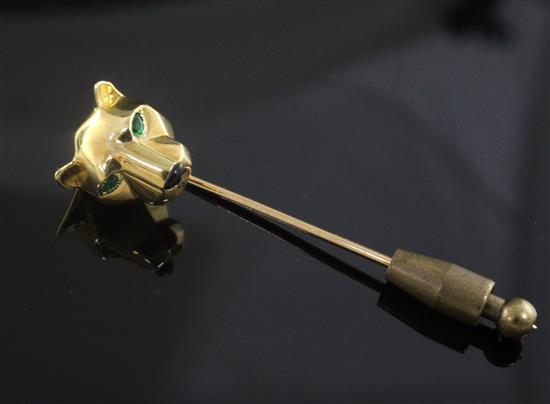 A Cartier 18ct gold, emerald and black onyx set Panther head stock pin, 53mm.